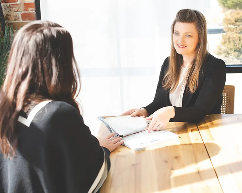 Courtney Cousino discusses legal document with client