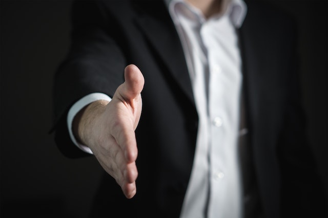 man extending hand for handshake