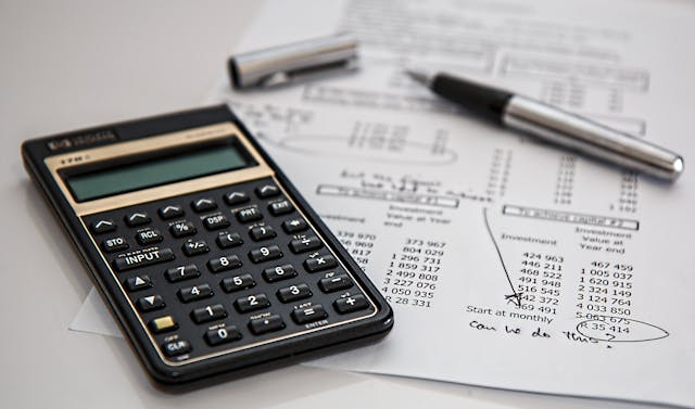 calculator, pen, and paper