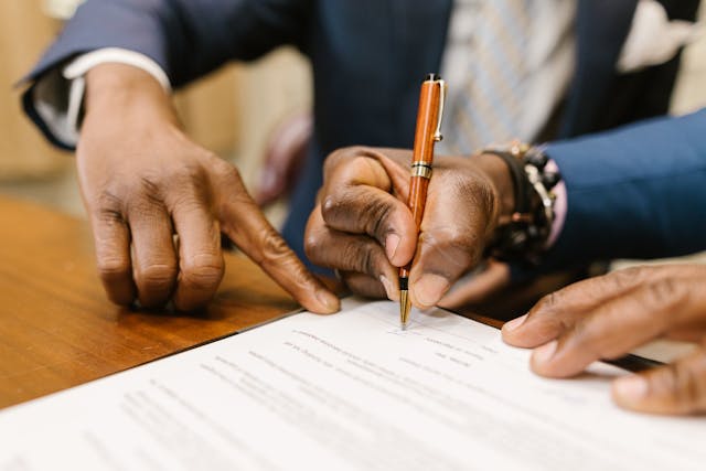two people signing document